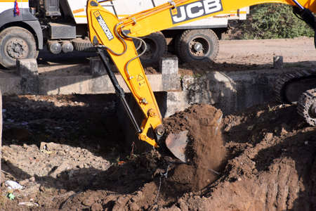 The modern excavator JCB performs excavation work on the construction site