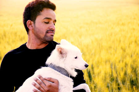 Indian rural model, photo shoot with her white dog, the morning in the wheat fields.