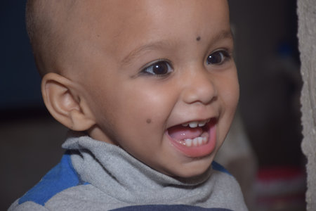 A beautiful bald girl. Look at the other side and smiles. Indoor photoshoot