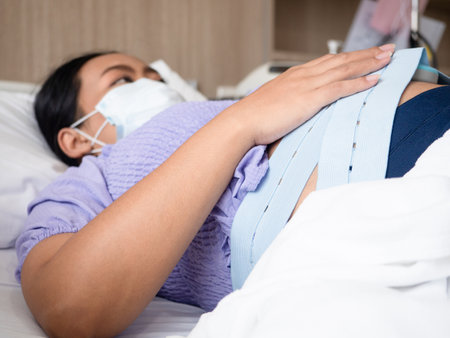 Pregnant woman laying on the bed waiting doctor for checking the babyの写真素材