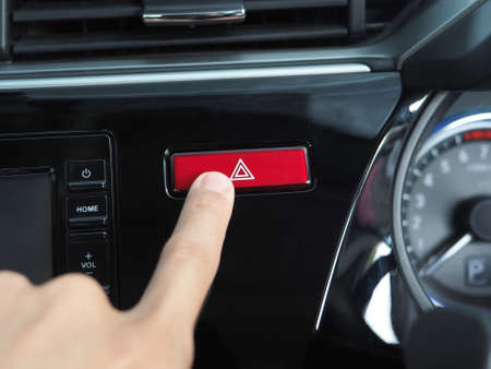 Finger at the emergency button of car shiny and cleanの写真素材