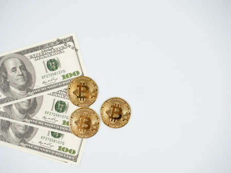 Gold bitcoins with money bill top view on white isolated backgroundの写真素材