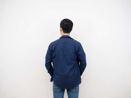 Handsome man back view in jean suit standing at studio white backgroundの写真素材