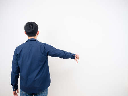 Back view of man jean suit standing show thumb down copy space white backgroundの写真素材