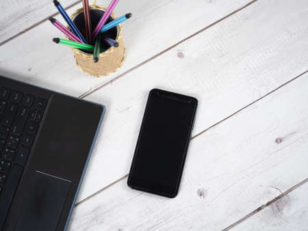 Workspace on table,Laptop pen box and mobilephone top viewの写真素材