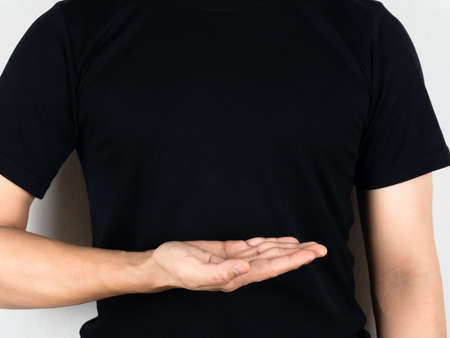 Man black shirt show empty hand on his body white backgroundの写真素材