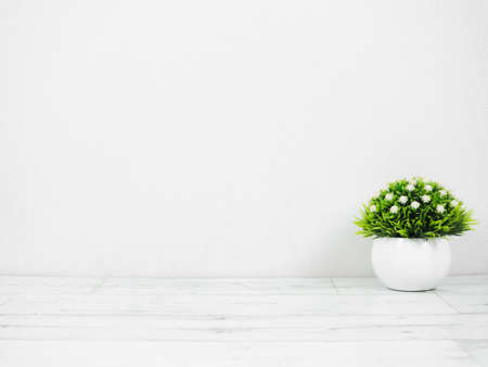 Small vase on wood table and white wall background copy space minimal styleの写真素材