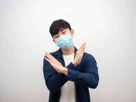 Sick man asian with mask cross arms looking at camera people sick concept on white backgroundの写真素材