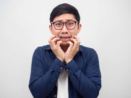 Asian man feeling fear something show hand up at his faceの写真素材