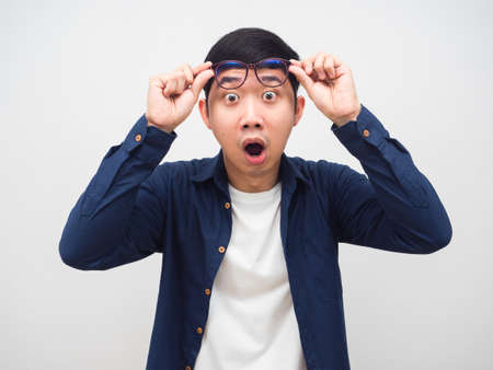 Man take off his glasses for looking and feeling shocked emotion white backgroundの写真素材