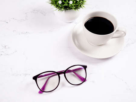 Glasses coffee cup with flower vase on the marble table background copy space morningの写真素材