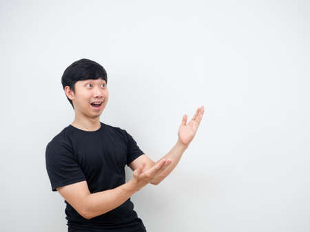 Asian man cheerful pointing hand at side present product concept copy spaceの写真素材