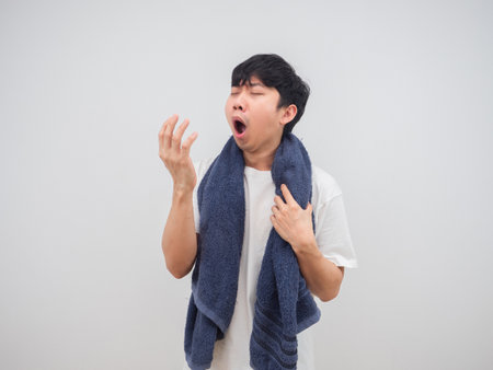 Sleepy man going to shower and yawn dont want to workの写真素材