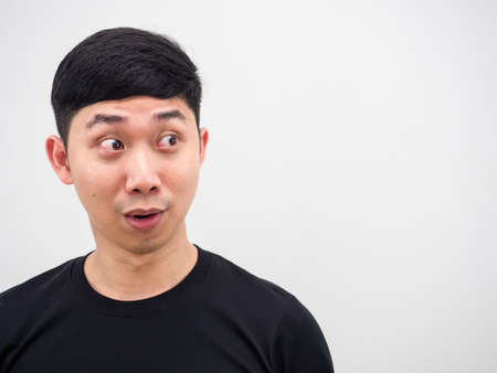 Closeup face of Asian man looking right side feel excited at his face on white backgroundの写真素材