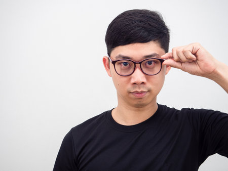 Closeup portrait face of Thai man wearing glasses handsome look hand catch at glasses on white isolated background,Asian man confedent face lookの写真素材