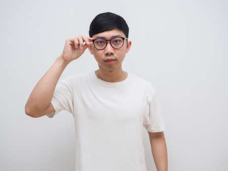 Asian man white shirt touch at his glasses feel confused at face white shirt look at camera on white...