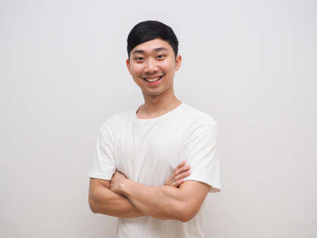 Young asian man cross arm white shirt with happy smile on his face feel confident on white isolateの写真素材
