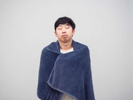Asian man feeling sleepy cover body by towel  portrait white backgroundの写真素材