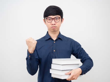 Asian man wearing glasses confident show fist up and holding book in hand portrait white backgroundの写真素材