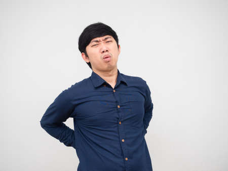 Asian man feeling pain his back unweel face portrait white backgroundの写真素材
