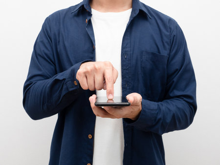 Closeup man holding mobile phone and touch screen for shopping crop body portrait white backgroundの写真素材