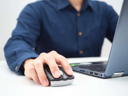 Close up man hand on mouse laptop working from home conceptの写真素材