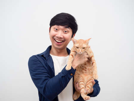 Man happy smiling holding domestic cat orange color looking at camera white backgroundの写真素材