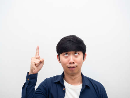 Man point finger at copy space feeling confused at his face portraitの写真素材
