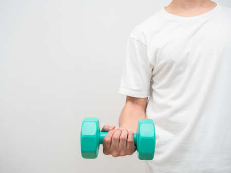 Man holding dumbbell green clolor white background crop shot copy spaceの写真素材