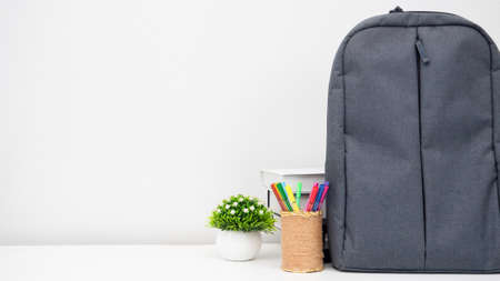 School backpack with pencil box and books on the desk white background copy spaceの写真素材