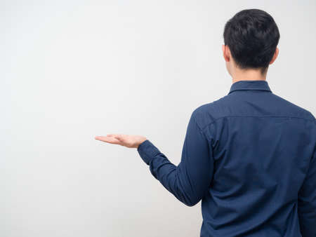 Man turn back show empty hand up for carry product copy space white background