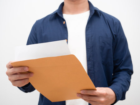 Man open envelope document and reading paper crop shotの写真素材