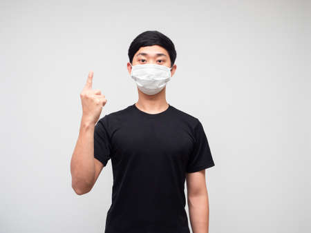 Asian man black shirt with mask show one finger counting on white isoated background