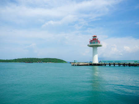 Lighthouse at port ship with mountain view landscape blue sky and oceanの写真素材