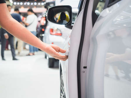 Hand open door car white color and blur event motor show conceptの写真素材