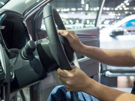 Man hand at steering wheel of car,Hand test drive at steering wheel concept new car