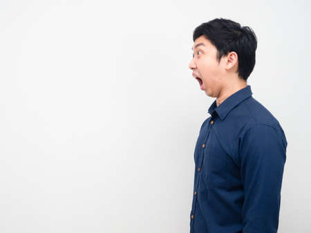 Man side view feeling shocked looking at copy space white backgroundの写真素材