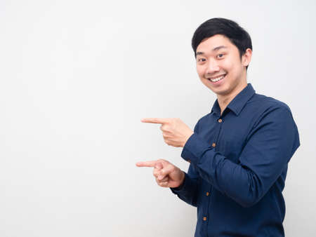 Asian man happy emotion gesture point finger at copy space white backgroundの写真素材