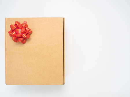 Gift box red ribbon on white table top view copy space
