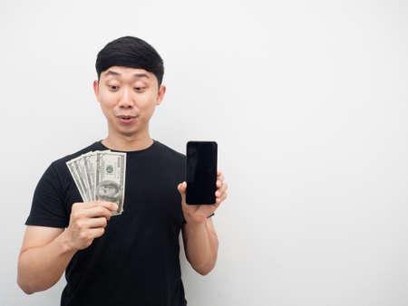 Man feeling excited looking money in hand copy spaceの写真素材