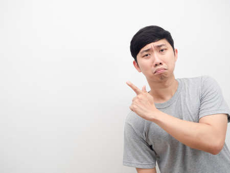 Asian man sad emotion point finger at copy space grey shirt