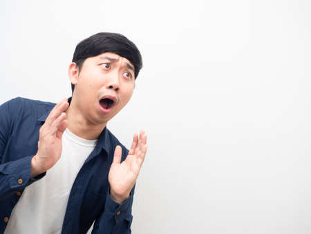 Asian man gesture excited looking at coy space white backgroundの写真素材