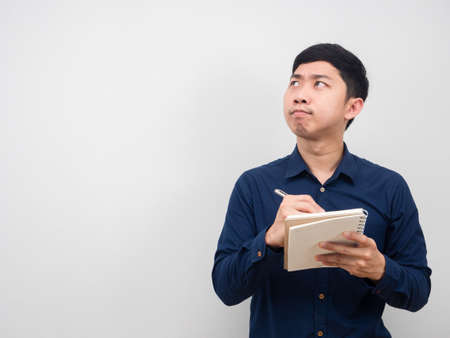 Man gesture writing on diary and looking at copy space