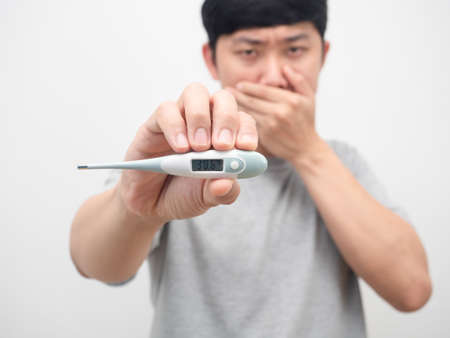 Man sickness holding thermometer white background