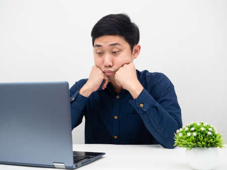 Man work from home using laptop feeling tried and want to sleepの写真素材