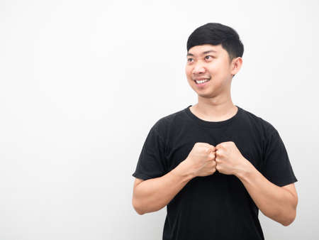 Man confident hit his fist smiling portrait looking at copy spaceの写真素材