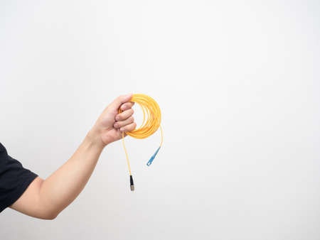 Hand holding loop fiber optic patch cord white isolatedの写真素材