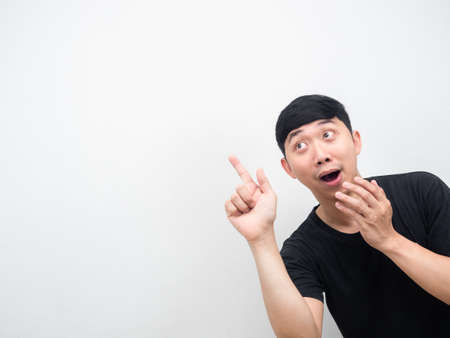 Asian man amazed emotion point finger at copy spaceの写真素材