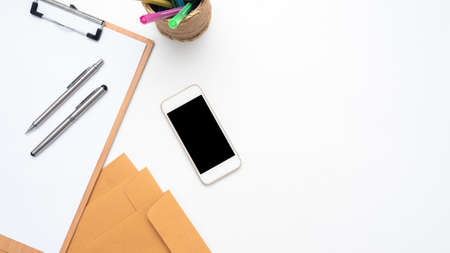 Smart phone,Pencil Box,Pen on woodboard document  on table top view copy spaceの写真素材