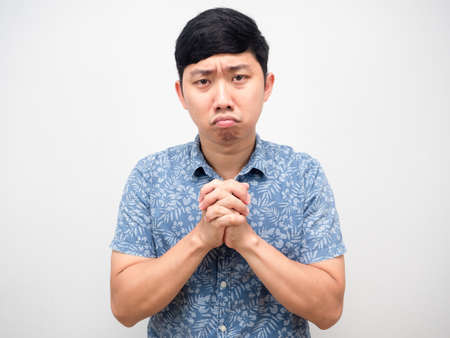 Man blue shirt joy hand,respect hand gesture please forgiving me portraitの写真素材